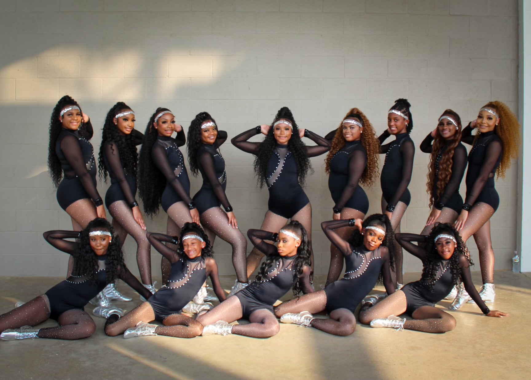 Royal Elite dancers in black performance attire