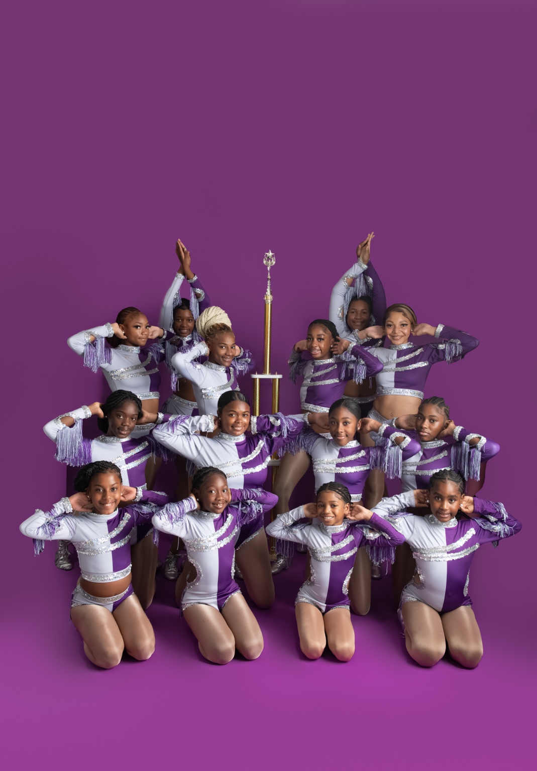 Royal Elite dancers in purple and white performance uniforms